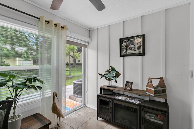 doorway featuring light tile patterned floors and a textured ceiling