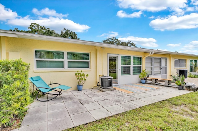 back of property featuring a patio area and central air condition unit