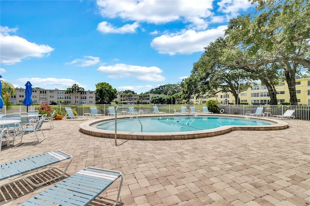 view of swimming pool with a patio