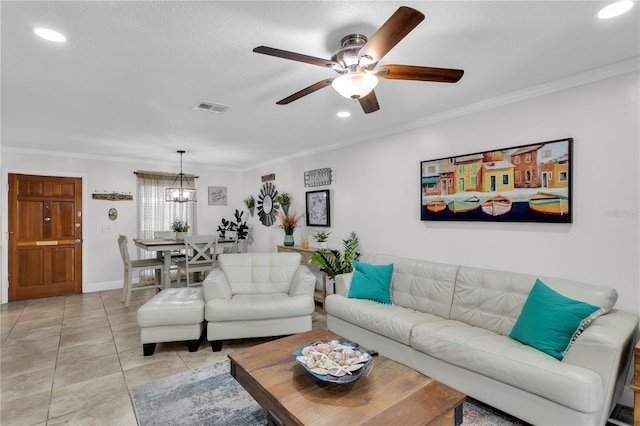 living room with ceiling fan with notable chandelier, ornamental molding, and light tile patterned floors