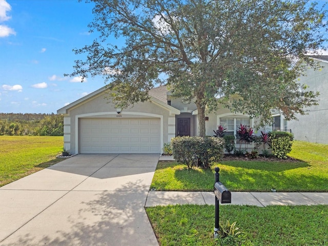 view of front of home with a front yard and a garage