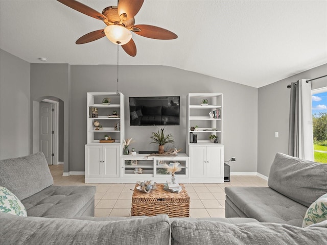 living room with a textured ceiling, ceiling fan, light tile patterned flooring, and vaulted ceiling