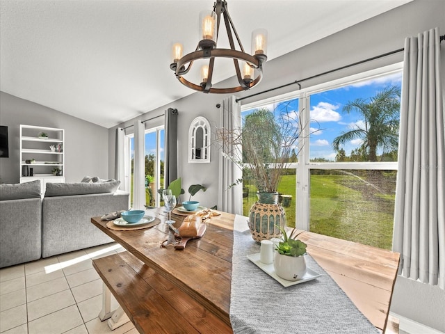 dining space with light tile patterned floors, vaulted ceiling, and an inviting chandelier