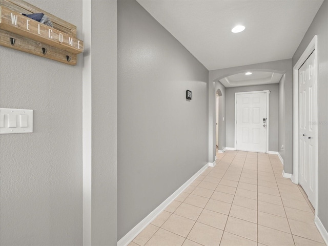 corridor featuring light tile patterned flooring