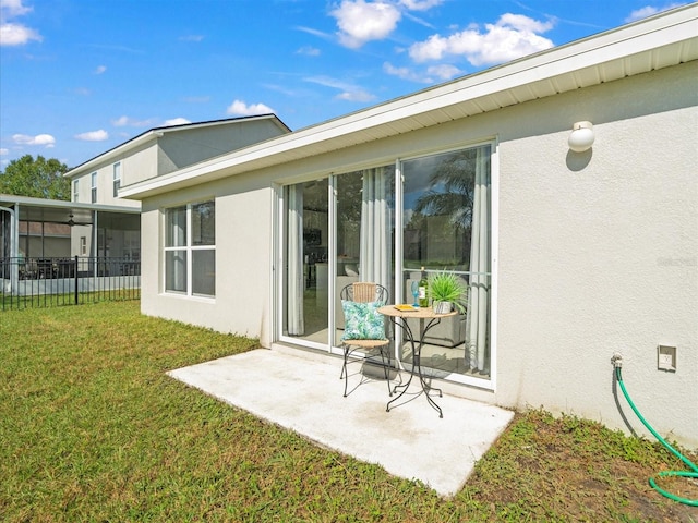 back of house featuring a patio area, a sunroom, and a yard