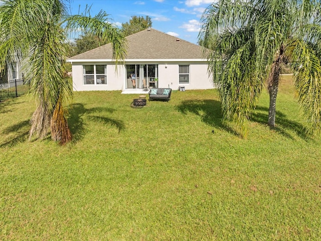 rear view of house with a lawn and an outdoor living space