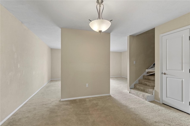 507 NW 39th Rd Unit 318, Gainesville, FL 32607 - carpeted empty room featuring stairs and baseboards