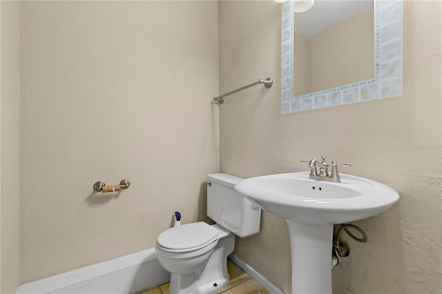 bathroom featuring sink, tile patterned floors, and toilet