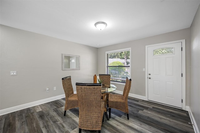 dining space with dark hardwood / wood-style floors