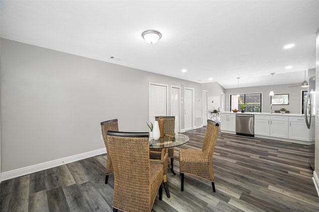 dining space featuring sink and dark hardwood / wood-style flooring