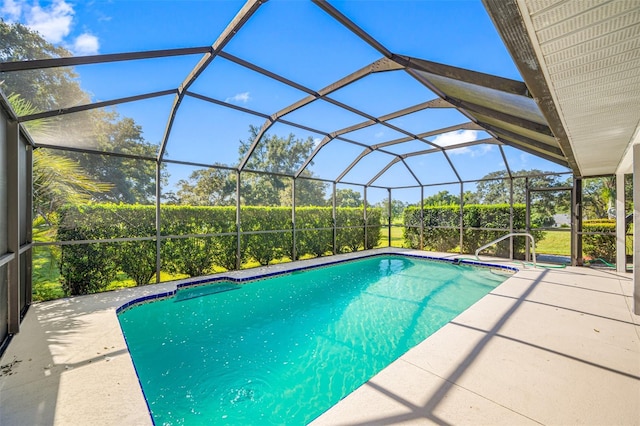 view of swimming pool with a patio and a lanai