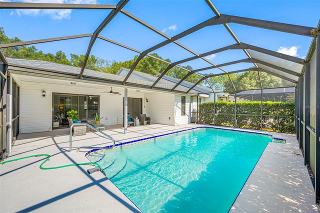 view of swimming pool with a lanai, a patio area, and ceiling fan