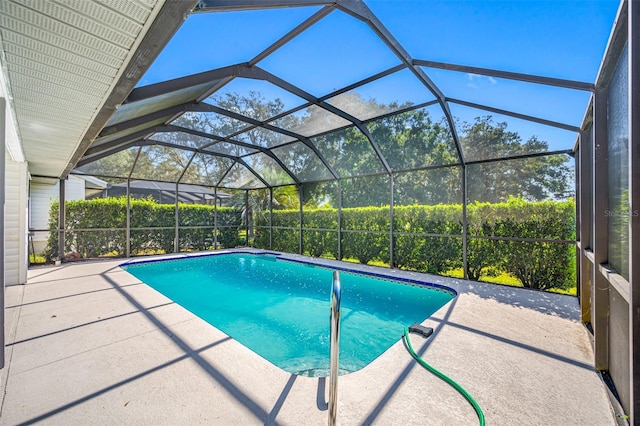 view of swimming pool with a patio and a lanai