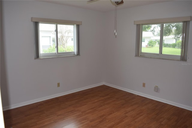 spare room featuring ceiling fan and dark wood-type flooring