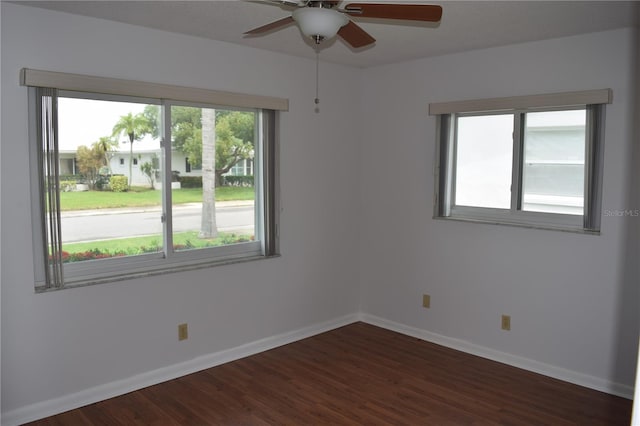 empty room with ceiling fan and dark hardwood / wood-style flooring