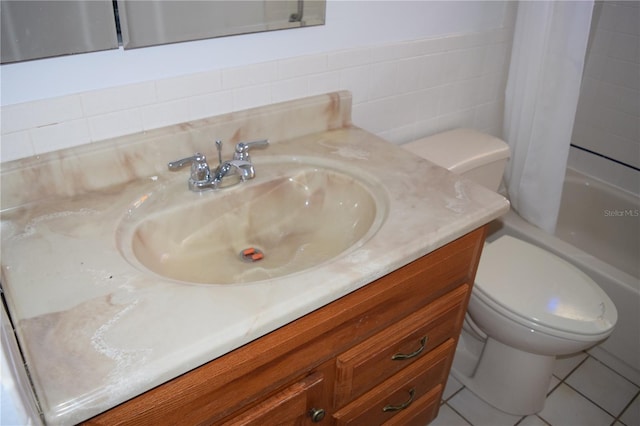 full bathroom with tile walls, shower / tub combo, vanity, toilet, and tile patterned floors