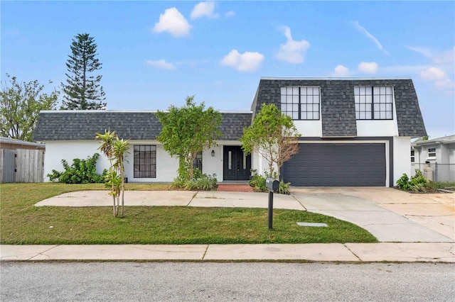 view of front facade featuring a garage and a front yard