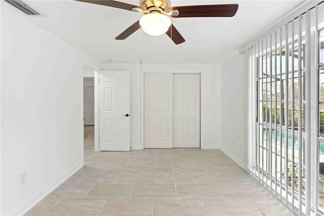 unfurnished bedroom with a closet and ceiling fan