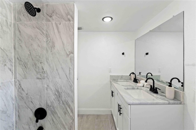 bathroom featuring vanity and tiled shower