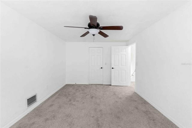 carpeted empty room with ceiling fan