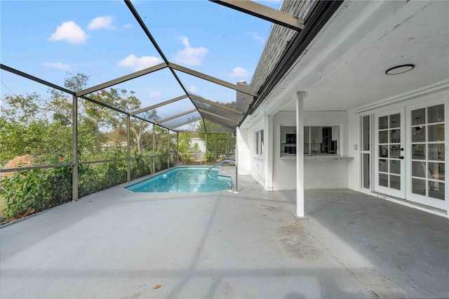 view of swimming pool featuring a lanai and a patio area