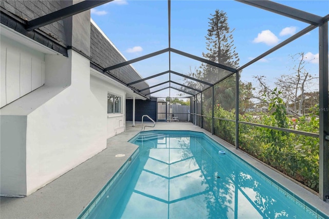 view of swimming pool featuring a patio and a lanai