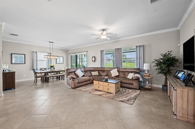 living room with ceiling fan with notable chandelier, crown molding, and light tile patterned floors