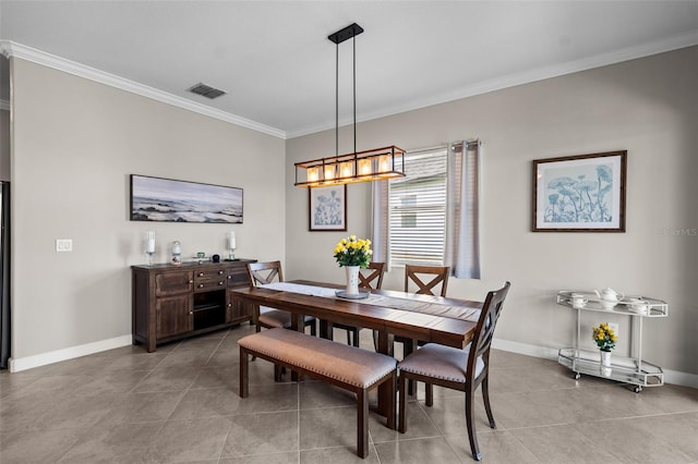 tiled dining space with an inviting chandelier and ornamental molding