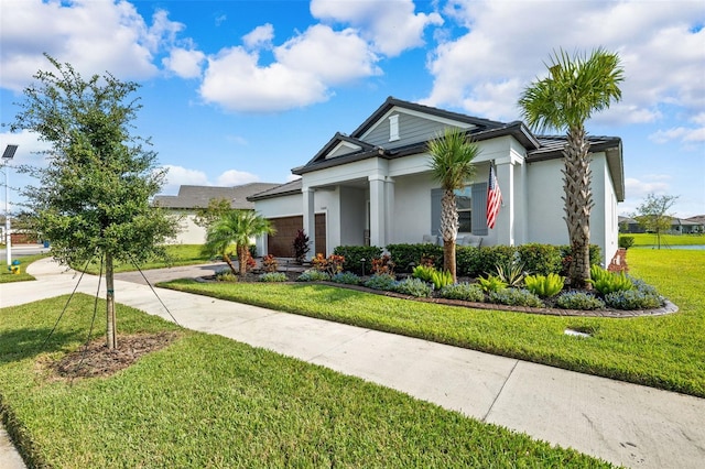 view of front of home featuring a garage and a front lawn