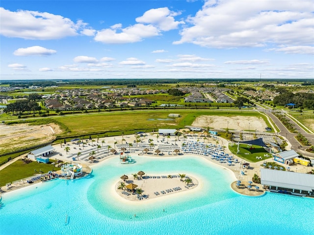 view of swimming pool featuring a view of the beach