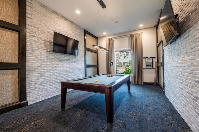 playroom with dark carpet, brick wall, and billiards