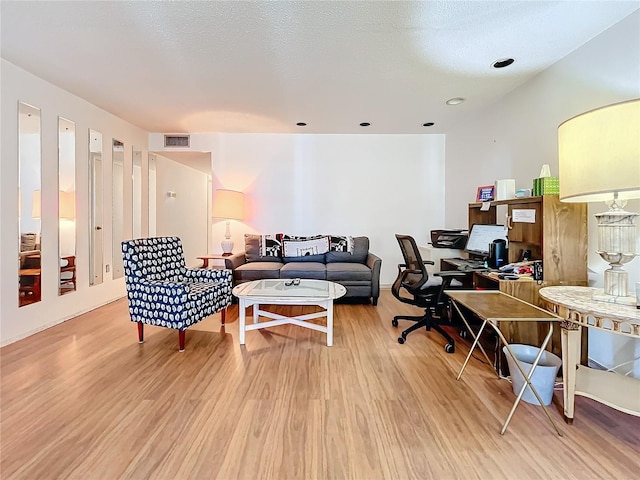 office space featuring a textured ceiling and wood-type flooring