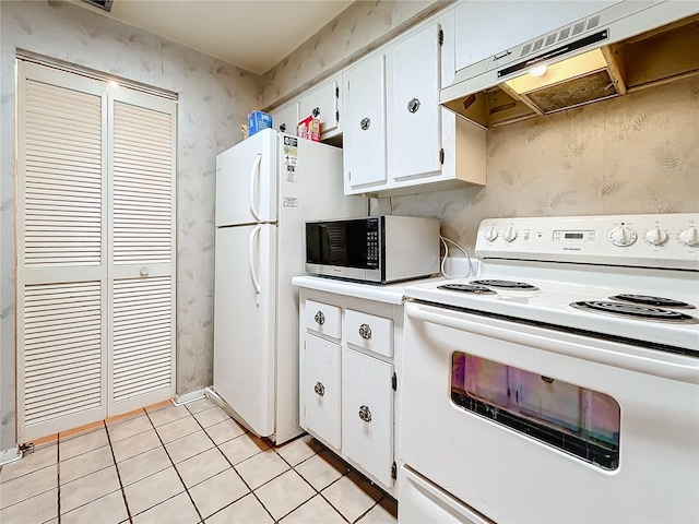 kitchen with white appliances, white cabinetry, light tile patterned floors, and exhaust hood