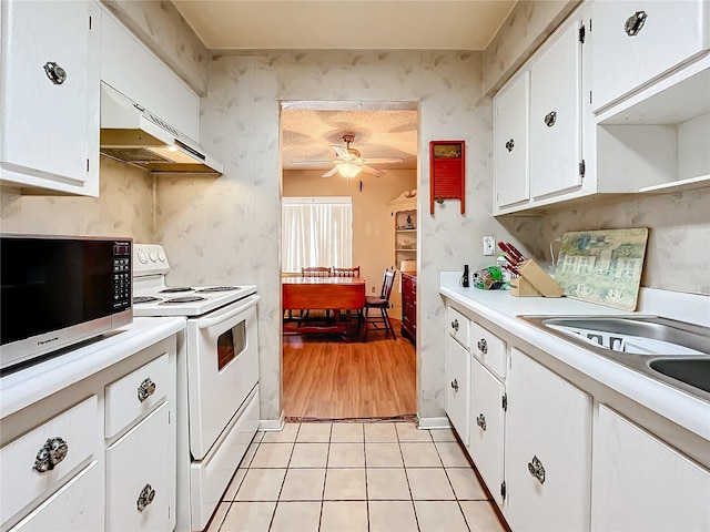 kitchen featuring white cabinetry, white range with electric cooktop, light tile patterned floors, and extractor fan