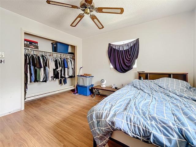 bedroom with ceiling fan, a textured ceiling, a closet, and hardwood / wood-style floors