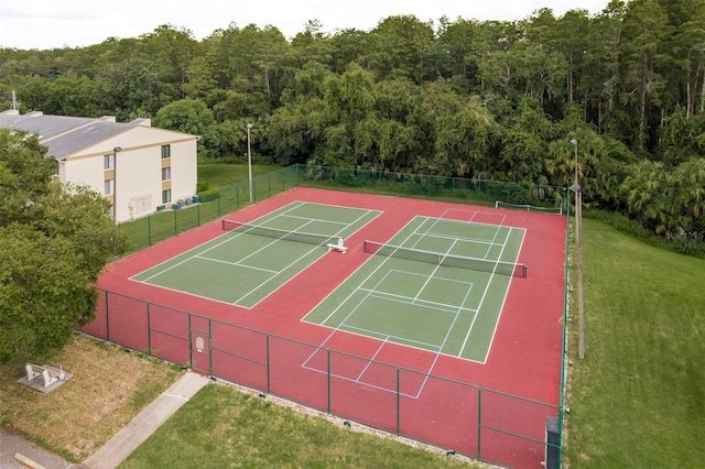 view of sport court with a yard