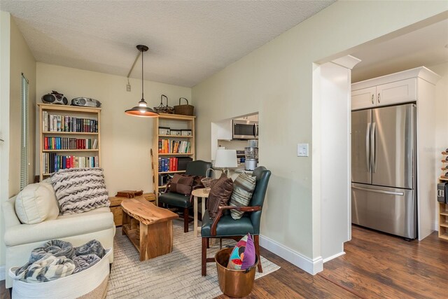 sitting room with dark hardwood / wood-style flooring and a textured ceiling