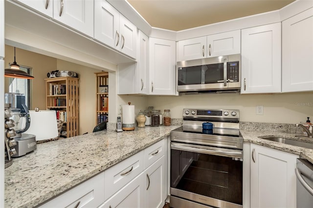 kitchen with white cabinetry, sink, and stainless steel appliances