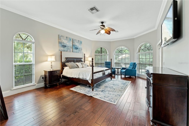 bedroom with baseboards, visible vents, ceiling fan, ornamental molding, and dark wood-type flooring