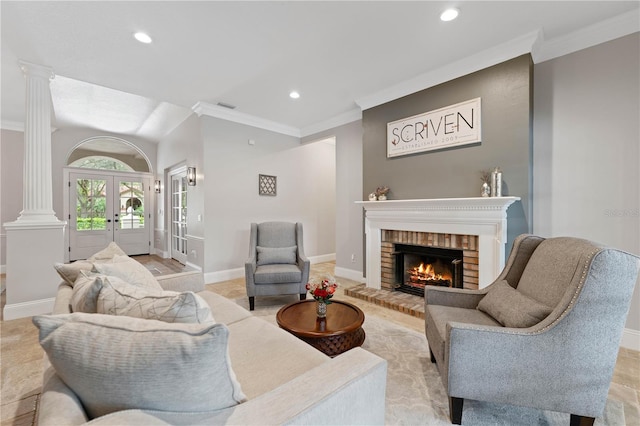 living area with ornamental molding, french doors, and ornate columns