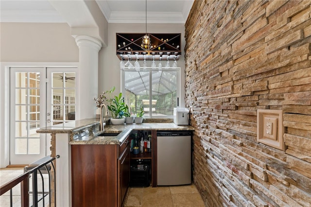 bar with decorative columns, decorative light fixtures, crown molding, fridge, and a sink