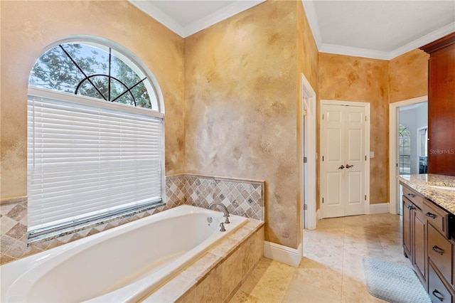 bathroom featuring a garden tub, crown molding, vanity, and baseboards