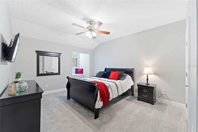 bedroom with a ceiling fan, lofted ceiling, light colored carpet, and baseboards