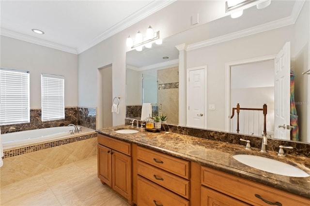 full bathroom featuring ornamental molding, a garden tub, a sink, and a tile shower