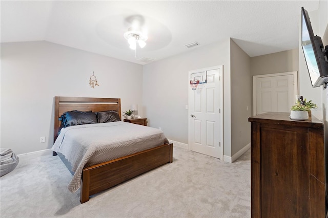 bedroom with visible vents, light carpet, vaulted ceiling, ceiling fan, and baseboards