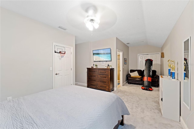 bedroom featuring light carpet, vaulted ceiling, visible vents, and baseboards