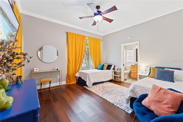 bedroom featuring crown molding, ensuite bathroom, a ceiling fan, wood finished floors, and baseboards