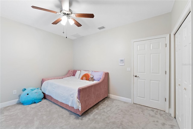 carpeted bedroom with a closet, visible vents, ceiling fan, and baseboards