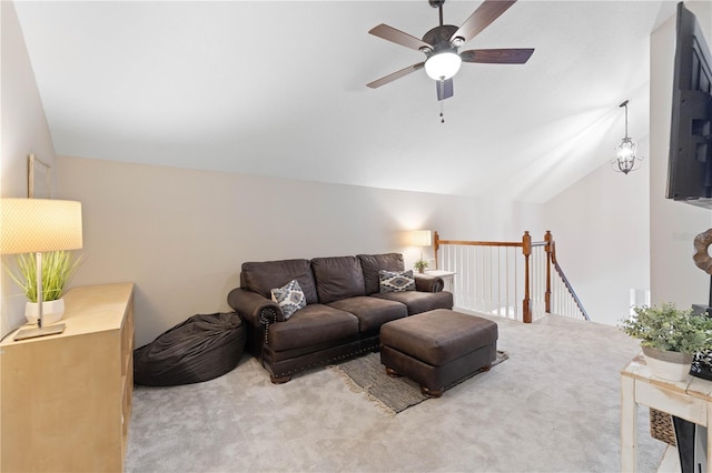 carpeted living room featuring vaulted ceiling and ceiling fan