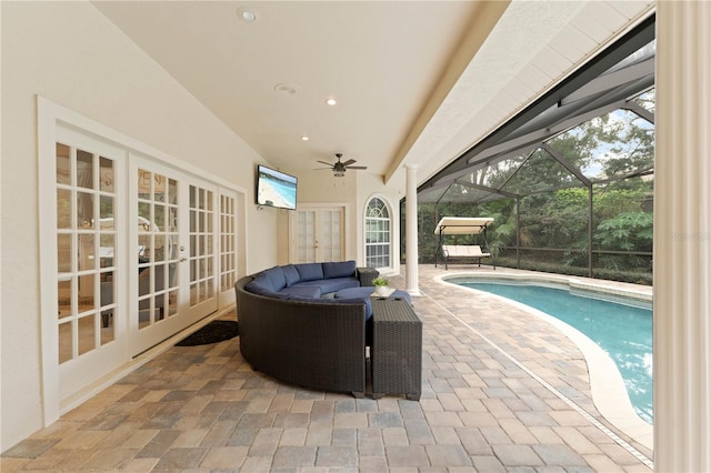 view of patio / terrace with a lanai, an outdoor hangout area, a ceiling fan, french doors, and an outdoor pool